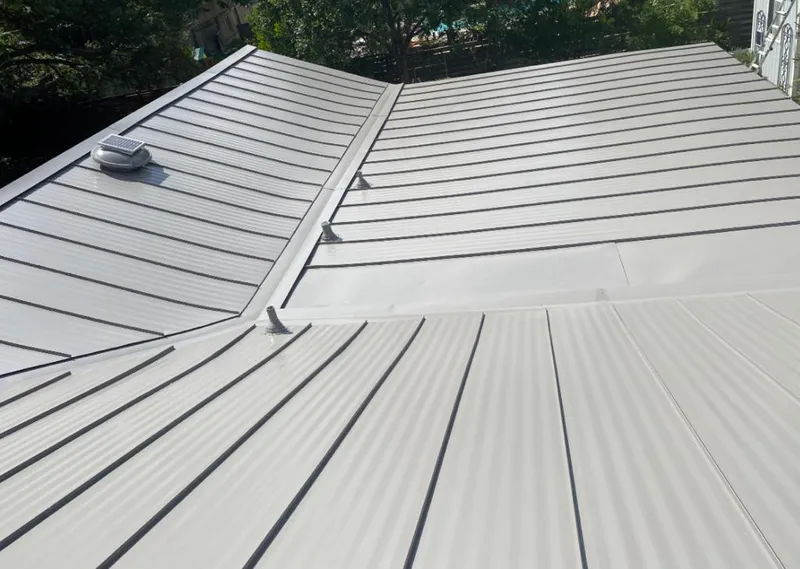 Solar attic fan installed on a metal roof for Roof Ventilation in Milan